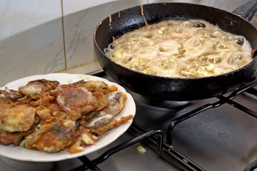 Fish roasting on frying pan at home kitchen