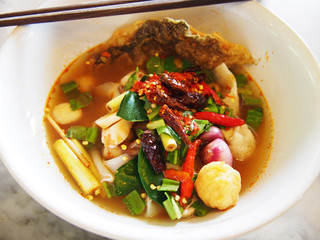 Thai spicy lemongrass flavored flat noodles with seafood