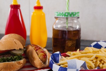 Close-up of snacks and cold drink on wooden table