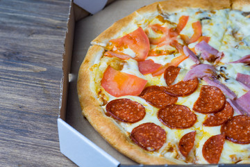 Pizza to order. Pizza in a cardboard box.