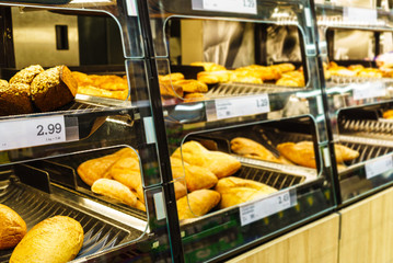 Fresh bread on store shelves with prices