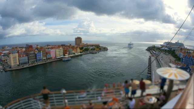 Cruise ship in the port of Curacao, time lapse, queen emma pontoon bridge closes after the ship has passed through