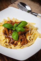 Tagliatelle with dark sauce.