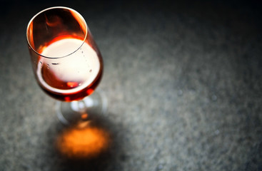 wine in a glass on a dark background