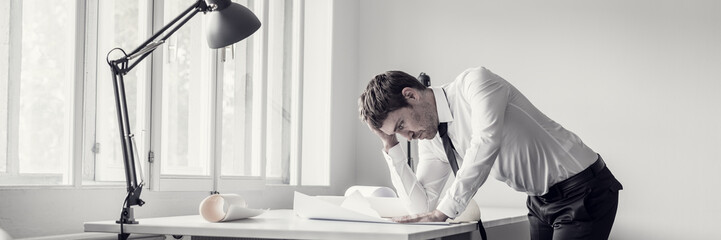 Frustrated business man analyzing plans