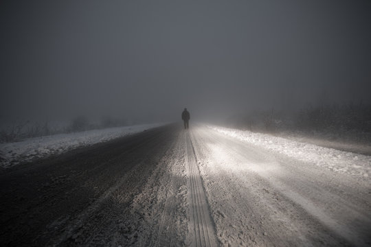 man in the fog on the road © serikbaib