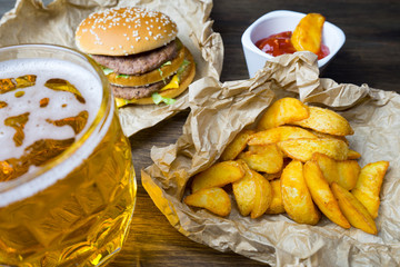 Fast food and a chilled glass of fresh light beer.
