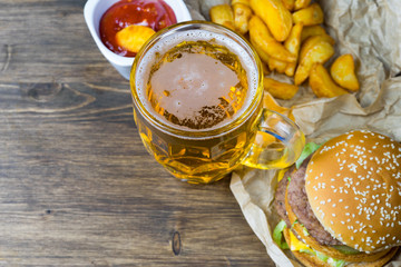 Fast food and a chilled glass of fresh light beer.