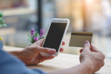 Man using mobile smartphone and credit card. Shopping Online