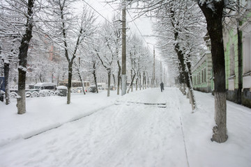 Snowfall on the city street. European winter scenic cityscape.