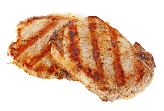 Two grilled pork chops on a white background