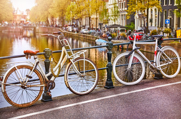 Fototapeta na wymiar Bike over canal Amsterdam city. Picturesque town landscape
