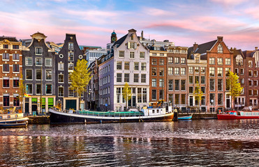 Naklejka premium Bridge over channel in Amsterdam Netherlands houses river Amstel
