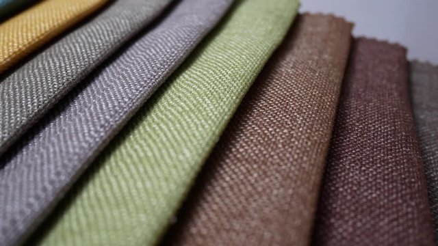 Colorful samples of fabric are spinning or rotation