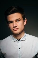 young brunette guy in a white shirt