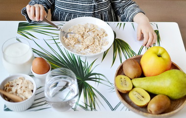 Little Girl Eating Flakes with Milk, Healthy Breakfast Fruits Egg 