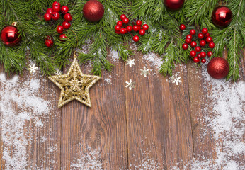 Christmas fir tree branches with toys on wooden