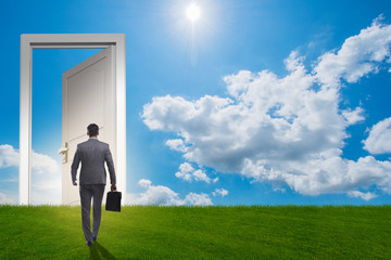 Businessman standing in front of door into future