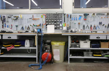 workshop with large workbench and a large number of tools for ma - obrazy, fototapety, plakaty