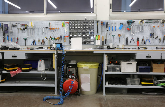workshop with large workbench and a large number of tools for ma