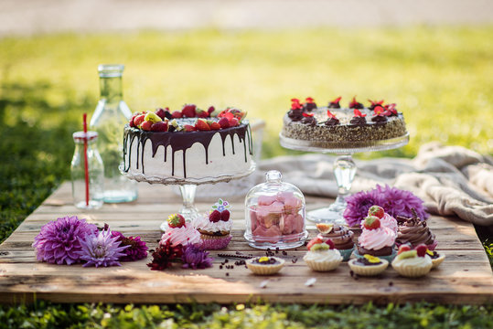 selection of tasty desserts and cakeson old wood background