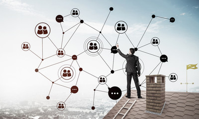 Businessman on house roof presenting networking and connection c