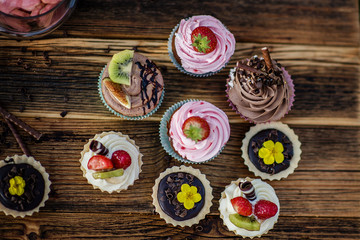selection of tasty desserts and cakeson old wood background