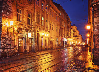 Mysterious narrow alley with lanterns in an old European city