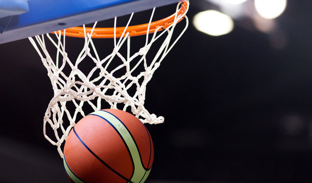 scoring during a basketball game - ball in hoop