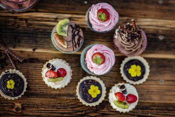 selection of tasty desserts and cakeson old wood background