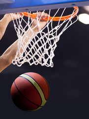 Fototapeta premium scoring during a basketball game - ball in hoop