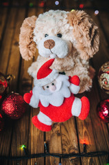 Plush dog as a symbol of 2018. Toy Santa claus, dog, Christmas balls.