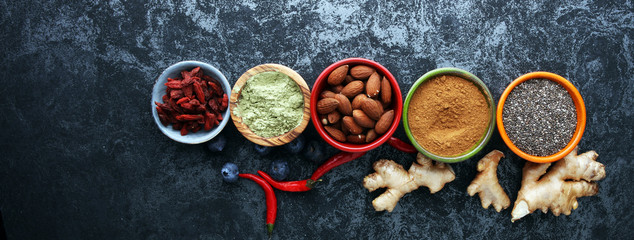 Fototapeta na wymiar superfood concept with bowls in diffrent colors of various superfoods.
