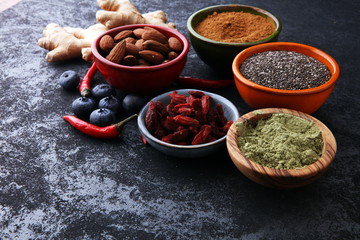 superfood concept with bowls in diffrent colors of various superfoods.