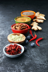 superfood concept with bowls in diffrent colors of various superfoods.