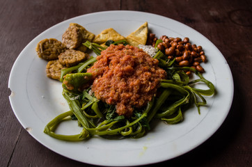 Indonesian dish kankung plecing (spicy water spinach dish) typical for Lombok island.