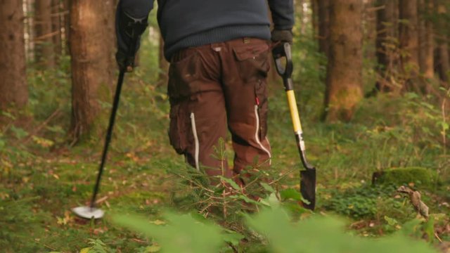 man treasure hunting forest medium shot