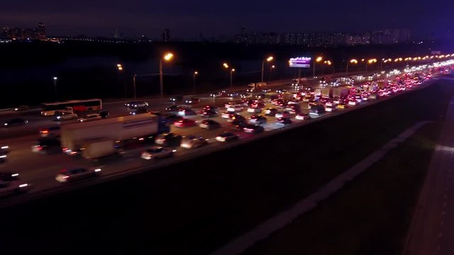 Aerial travelling shot of huge motorway traffic jam in the evening rush hour