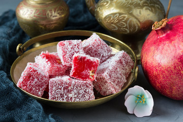 Segments of pomegranate, and  dessert  Turkish delight