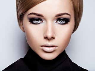 Woman's face with  fashion black makeup of eye and long black eyelashes.