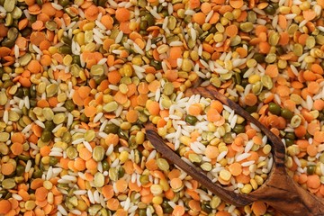 Rice and lentils backgrpund with a wooden scoop, selective focus