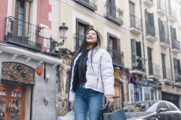 Naklejka premium Attractive Chinese girl shopping for Madrid