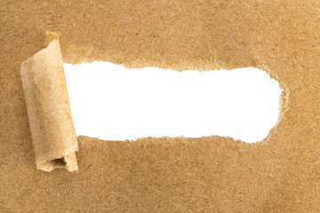 holes in brown paper with torn sides over paper background with space for text