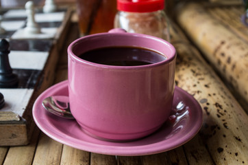Black coffe in pink cup.