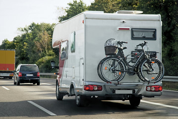 Caravan with bicycles and cars in road at Switzerland