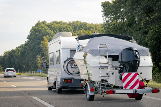 Caravan with trailer for motor boats road in Switzerland