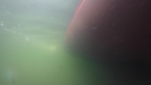 An underwater shot of large ocean fishing boat in water