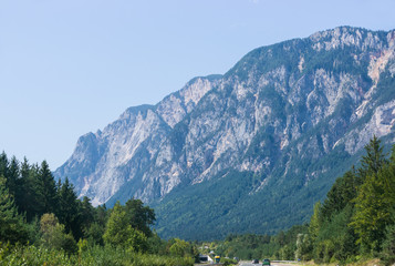Fototapeta na wymiar Road with cars and Alps mountains in Austria summer