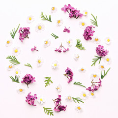 Wreath with daisies and violet lilac flowers