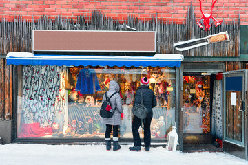 Tourists at Street Market stall with traditional souvenirs winter Rovaniemi